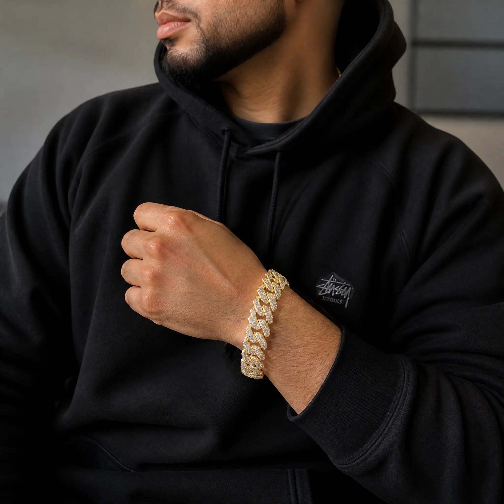 A model wearing an iced-out moissanite eagle Cuban link bracelet.